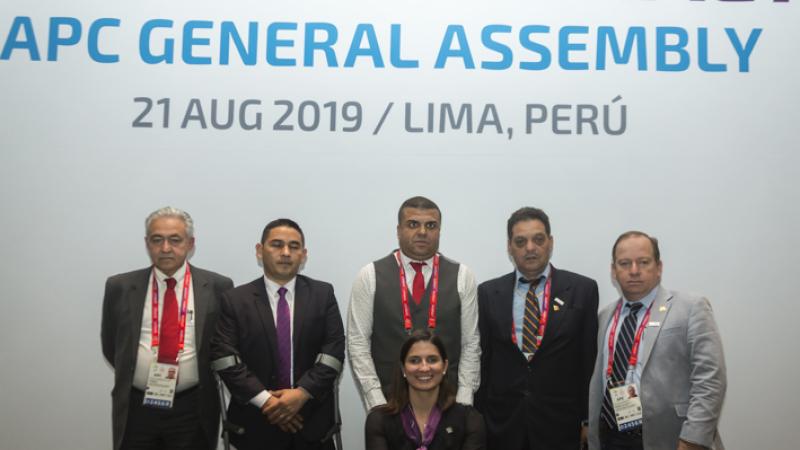 a group of men and one woman in suits