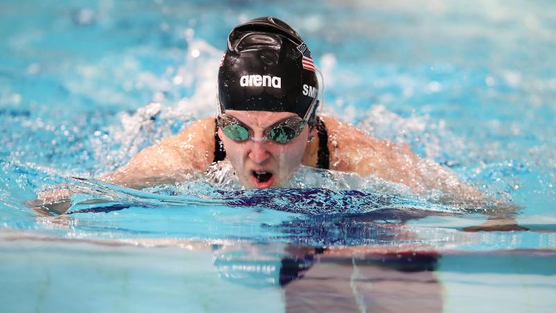 a female para swimmer doing breaststroke