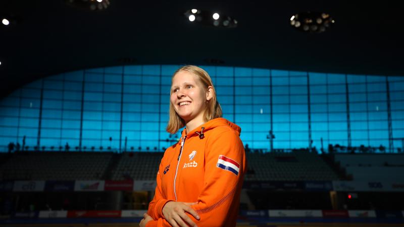 Dutch female swimmer poses for portrait photo inside venue