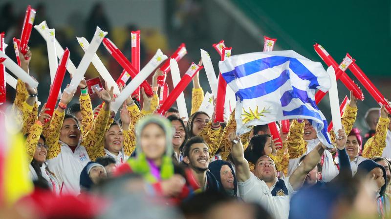 a group of volunteers waving plastic banners