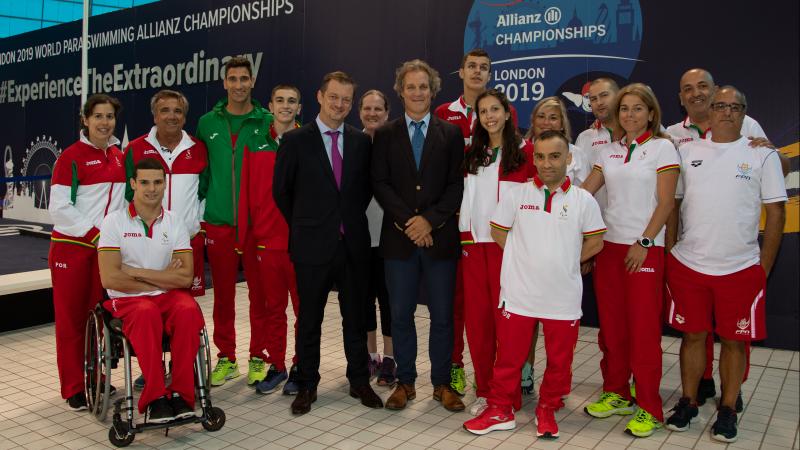 A male wheelchair user and 15 standing men and women