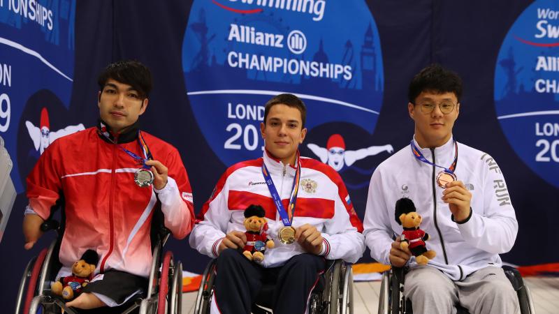 three male Para swimmers on the podium 