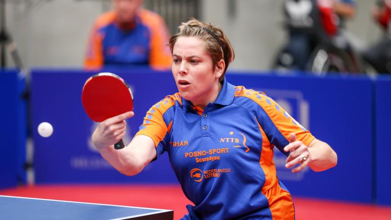 Woman hits return shot in table tennis