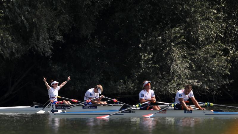 British rowing crew celebrates while Dutch rowing crew looks disappointed