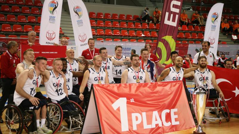 Group of wheelchair basketball players pose for photo