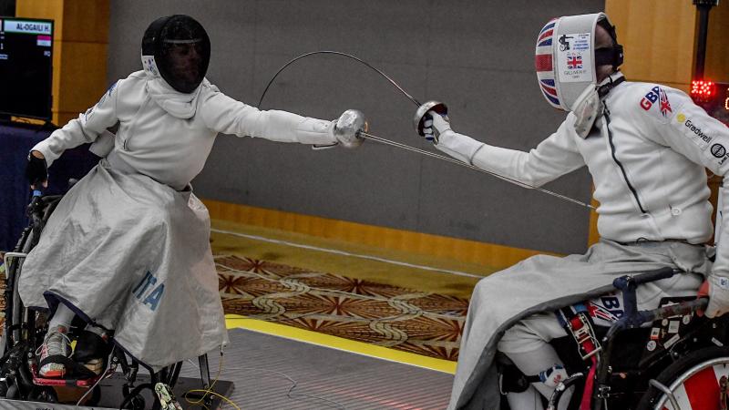 Two men's competing against each other in the epee competition
