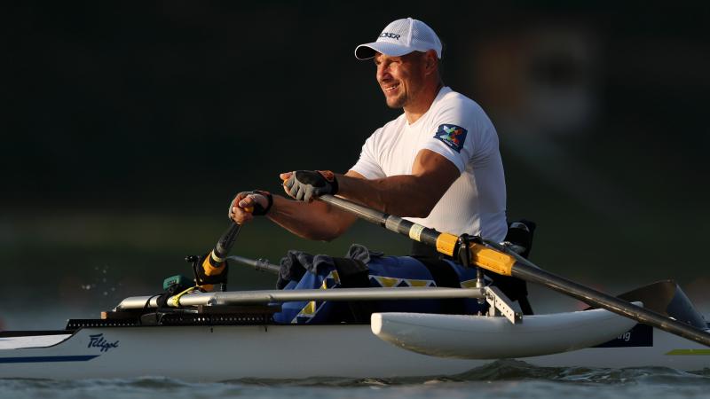 Man in row boat looks on