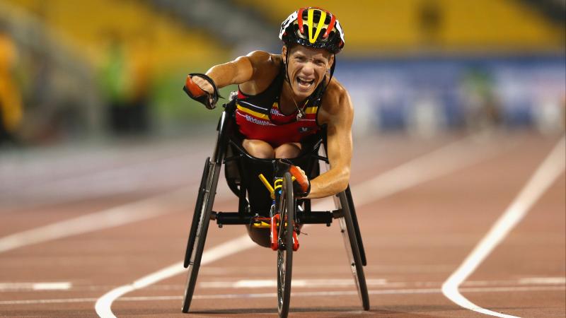 Marieke Vervoort celebrates as she crosses the finish line