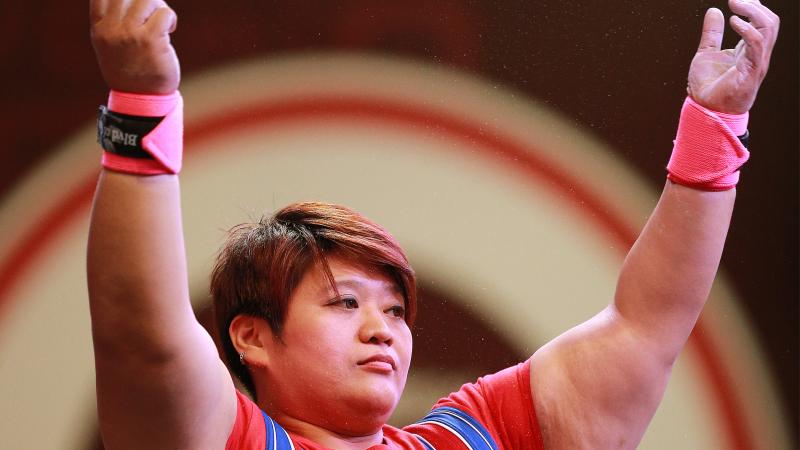 Chinese Taipei's powerlifter Tzu-Hui Lin raises her arms