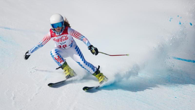 A female Para alpine skier competing on the snow