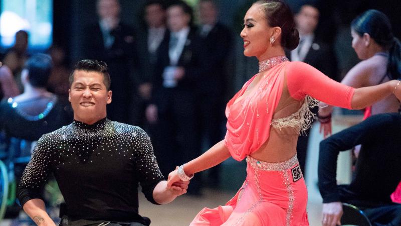 Man in wheelchair dancing with female standing partner