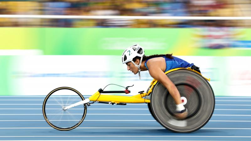 A female wheelchair racer on a blue track