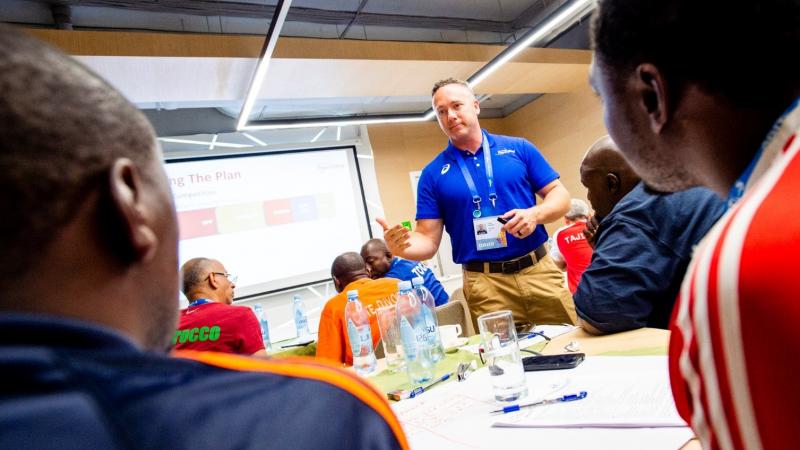 Powerlifting mentor speaks during an educational course