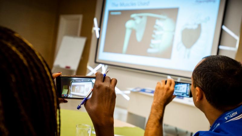 Participants of powerlifting educational course take photos with their phones