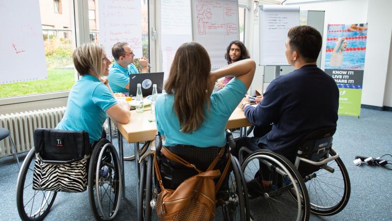 Five Proud Paralympian Educators work in group during a course in Bonn