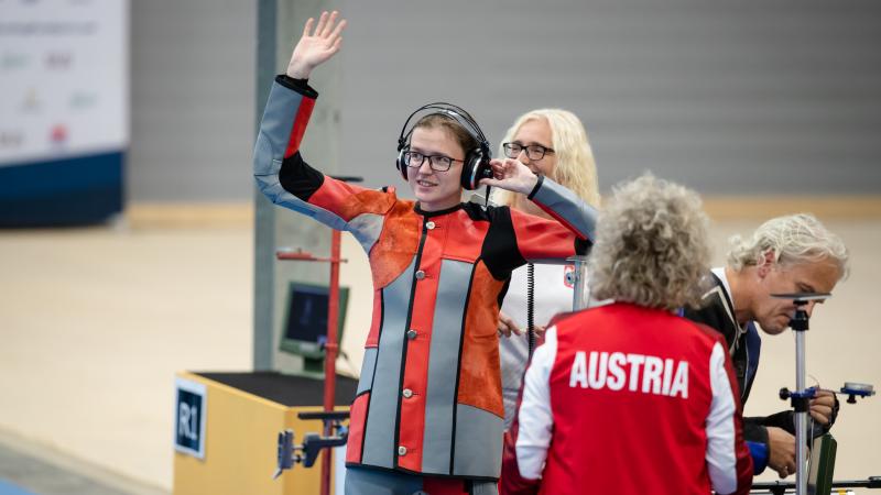 Female vision impaired shooter waves at audience