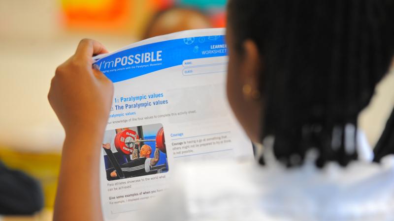 Girls read I&#039;mPOSSIBLE education programme materials