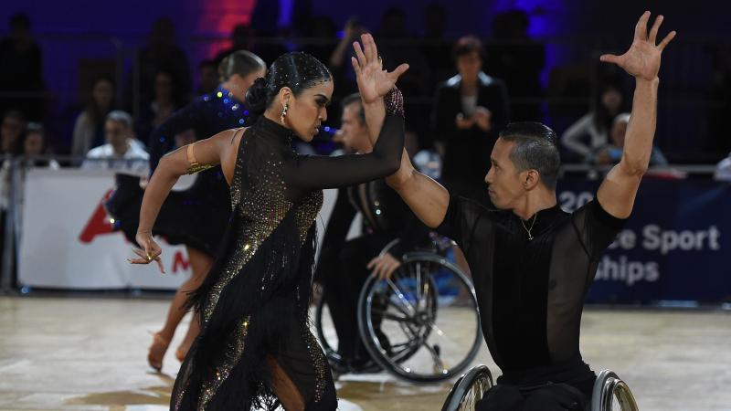 Female standing dance and wheelchair partner perform in the combi Latin 2