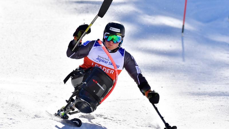 A male sitskier competing in the snow