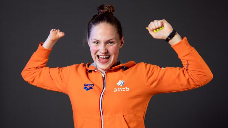 A woman smiling and stretching her arms 