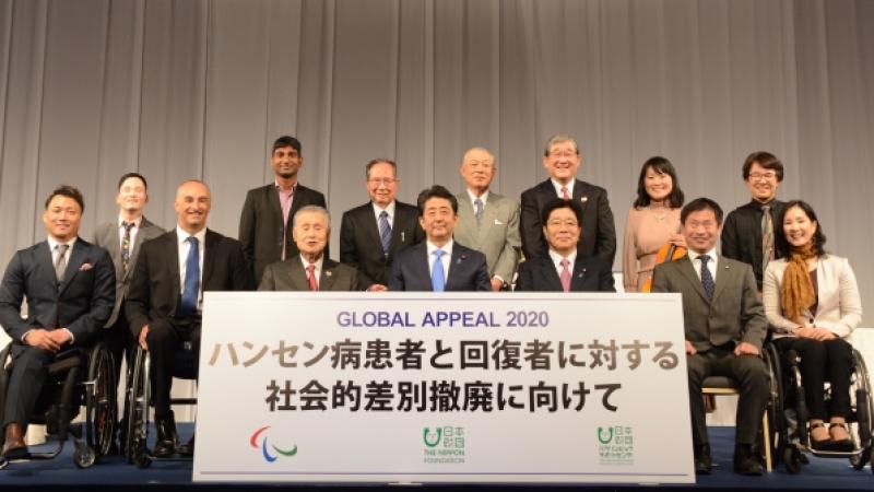 Group photo of Japanese people around a big banner