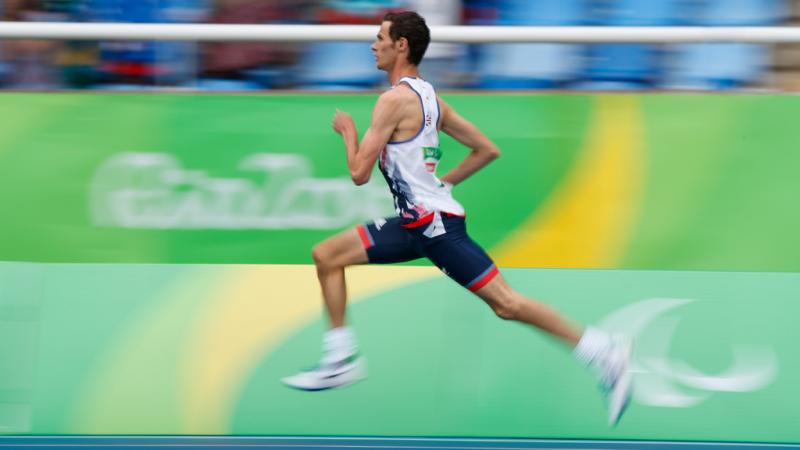 A man running on an athletics track