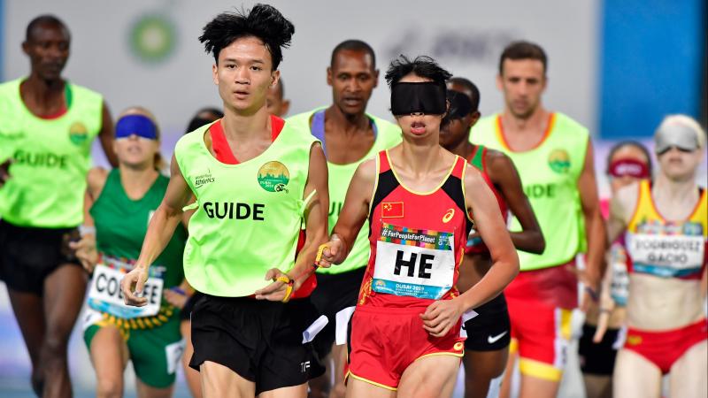 Chinese vision impaired runner with her guide