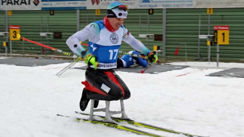 A male sit-skier competing on the snow