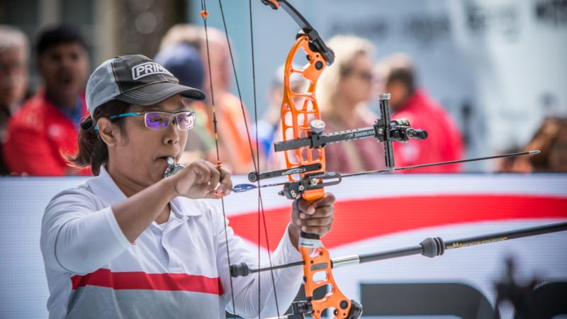 Signapore female archer prepares her bow and arrow