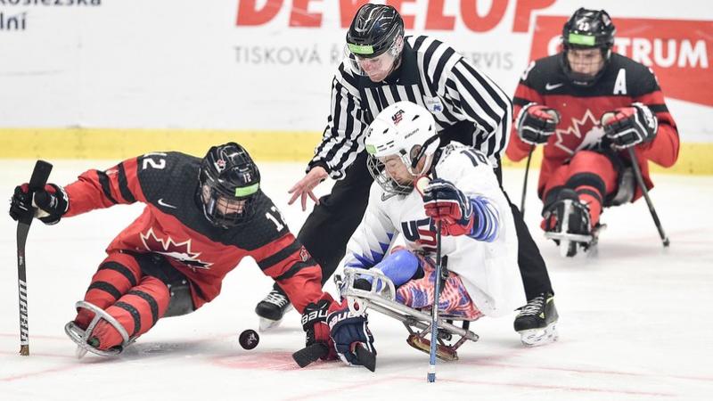 Greg Westlake (CAN) and Declan Farmer (USA) battle for the puck