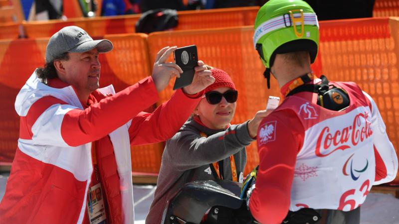 Journalists interviewing a sit-skier