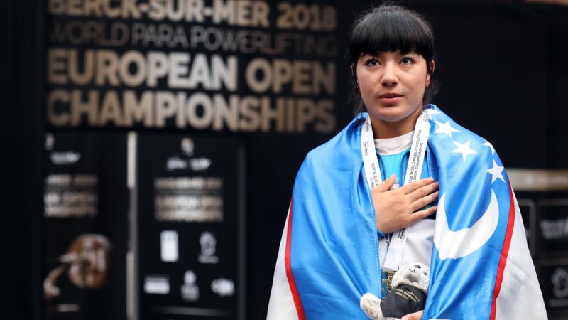 Shakhzoda Mamadalieva touching her chest with her right hand 