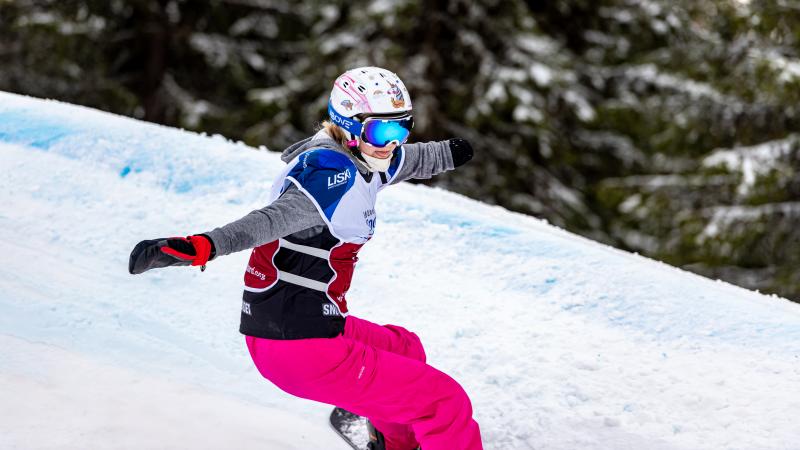 A female Para snowboarder competing 