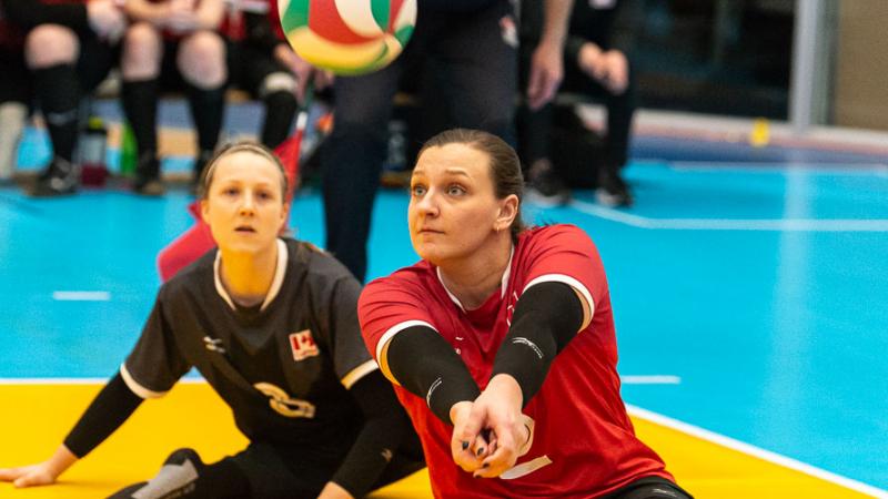 Female sitting volleyball player hits a bump