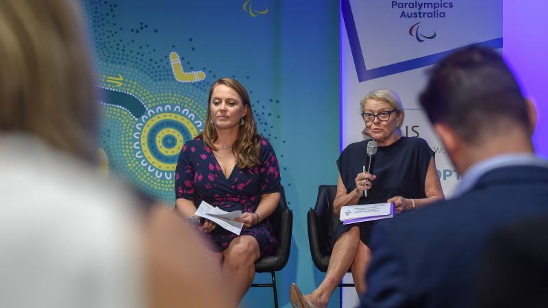 Two women leading a panel discussion