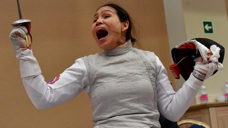 Female wheelchair fencer celebrates