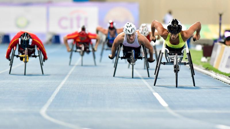 A group of female wheelchair racers on a track