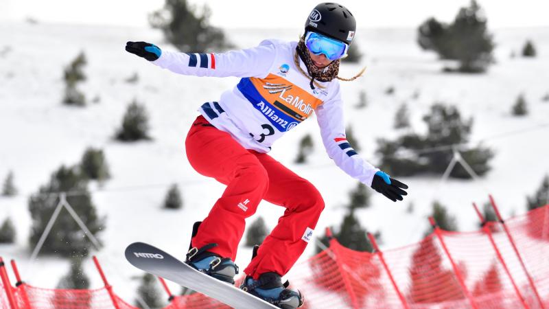 A female Para snowboarder competing
