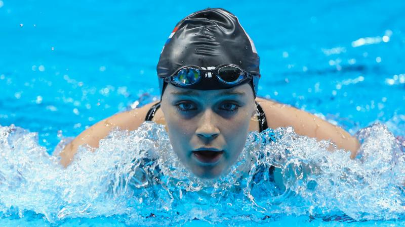 Female swimmer competing in the water