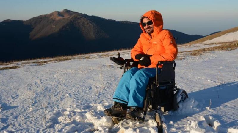 A man in an electric wheelchair on the snow
