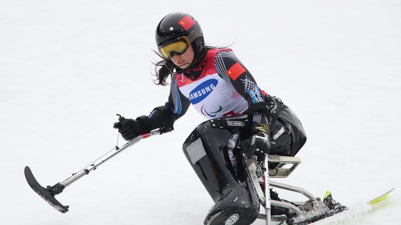 A female Para alpine sit-skier competing