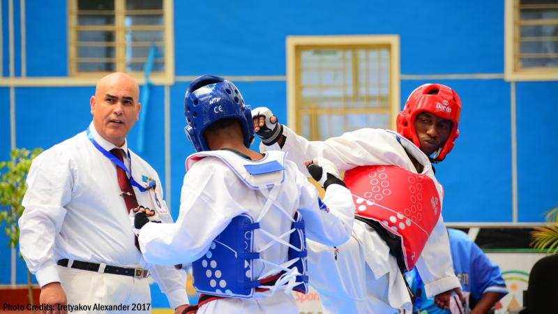 Two African male taekwondo fighters competing 