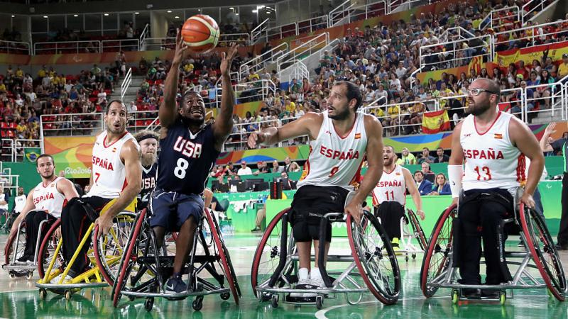 Black man in wheelchair grabs rebound