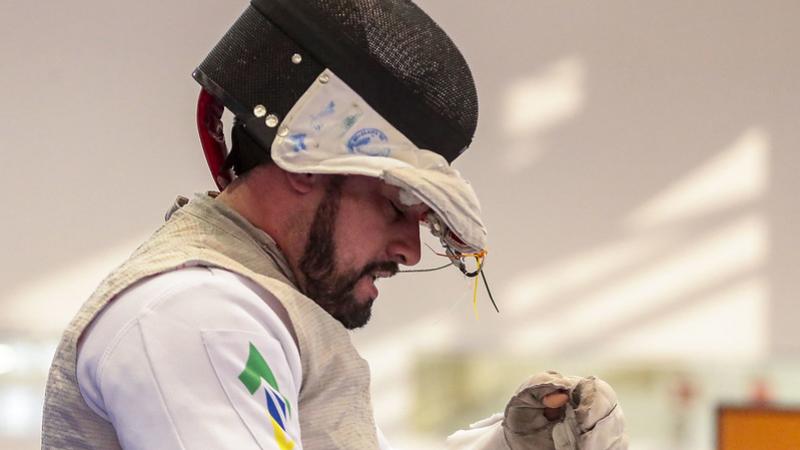 Brazilian male wheelchair fencer pulls off his mask