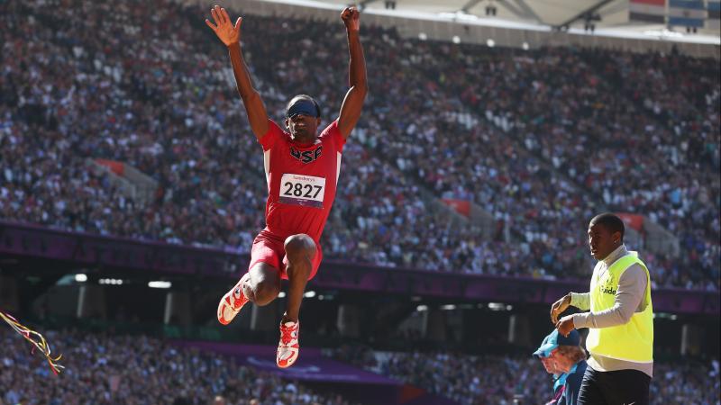 Lex Gillette in the air after jumping in the long jump event at London 2012