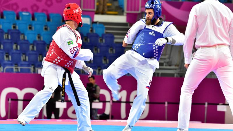 Two male taekwondo fighters sparring