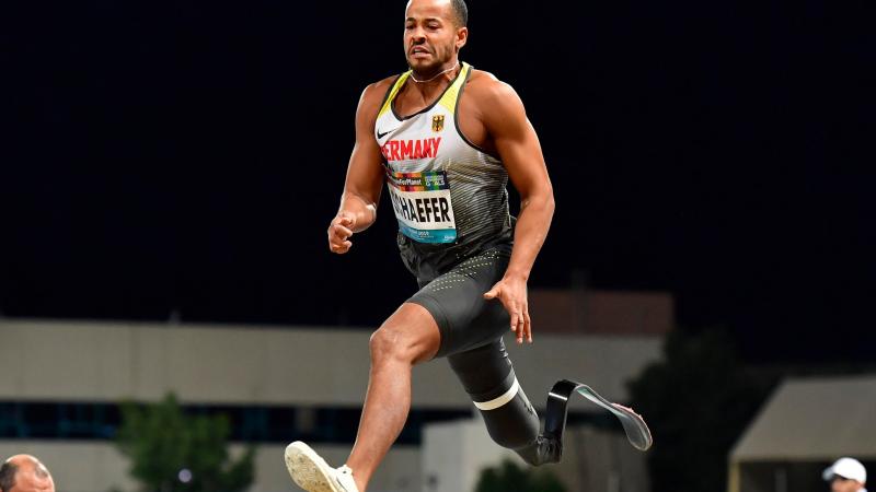 A man with a prosthetic leg jumping 