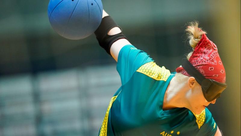 Female goalball player winds up to throw the ball