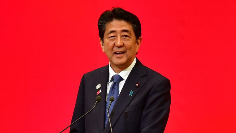Photo of Japanese male Prime Minister speaking on podium