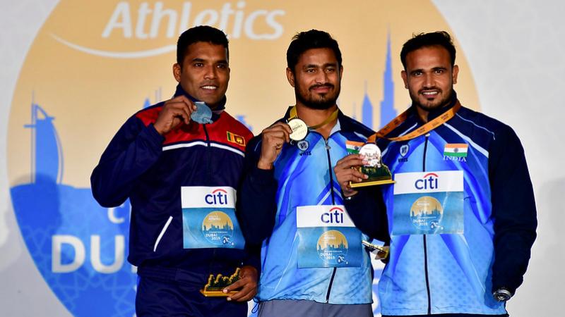 Three male javelin throwers on the podium